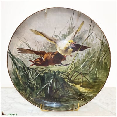 Grand plat lenticulaire porcelaine de Montereau peint avec vol de canards, diam. 45 cm, (Fin XIXe)